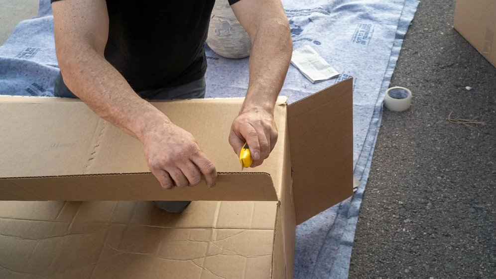 Movers preparing household items for transport